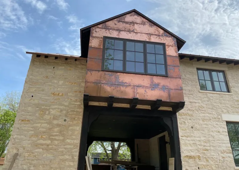 Copper metal panel facade on a stone building for Roof Repair in Scaggsville