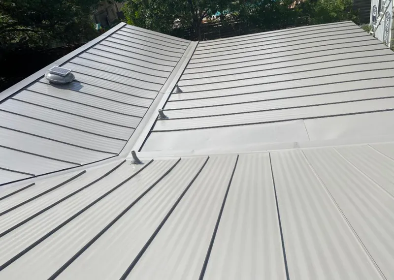 Solar attic fan installed on a metal roof for Roof Ventilation in Scaggsville